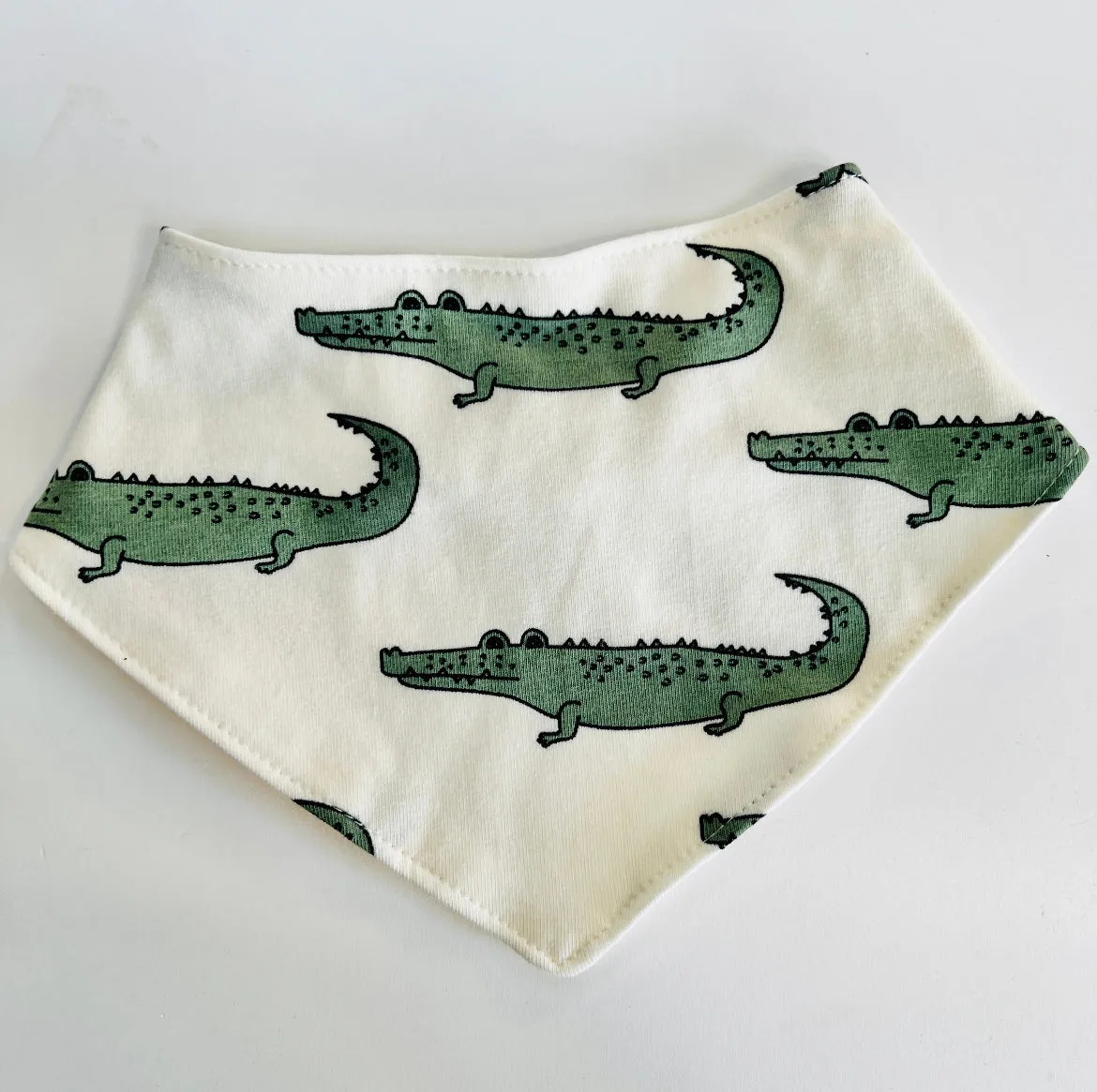 Eddie & Bee organic cotton Baby Dribble bib  in Cream "Enormous Crocodile" print.